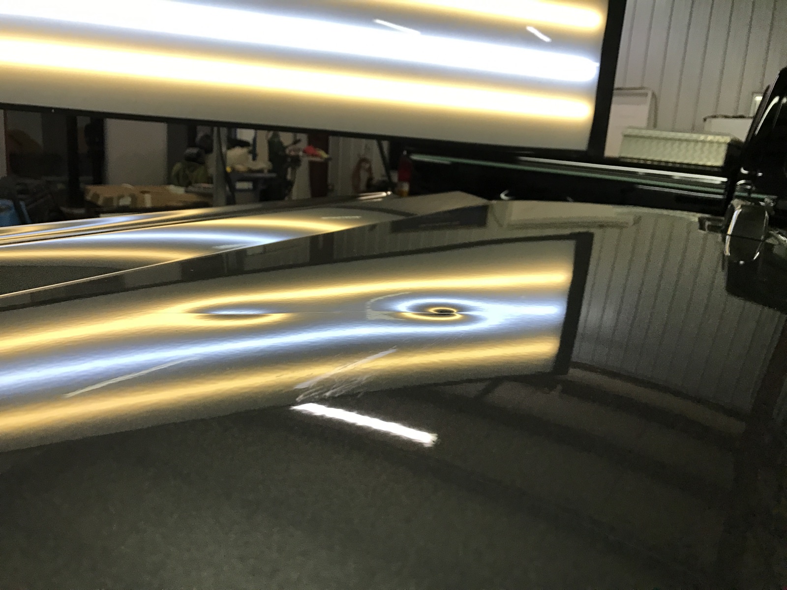 Close-up of vehicle-panel dents revealed by PDR reflection lighting