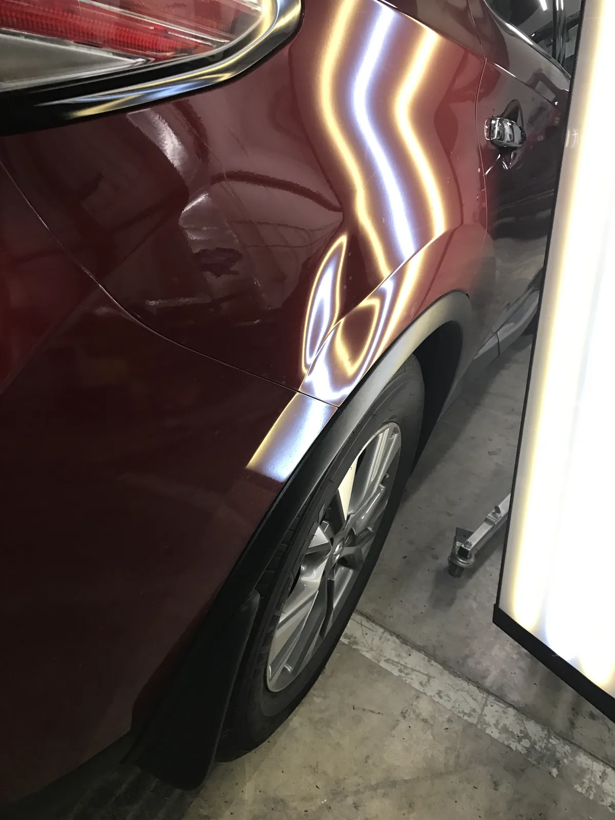 Nissan Murano panel dent before repair, viewed under reflection lighting