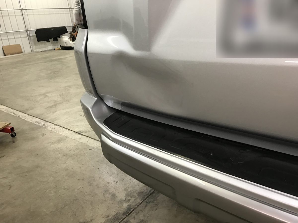 Dent damage on a Toyota 4Runner rear liftgate before paintless dent repair
